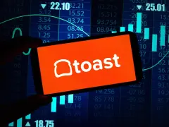 Toast Inc logo on smartphone, tech background behind.