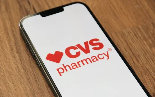 CVS Pharmacy logo on smartphone screen on wooden table background
