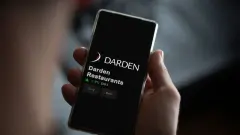 The logo of Darden Restaurants on the screen of an exchange. Darden Restaurants price stocks, $DRI on a device.